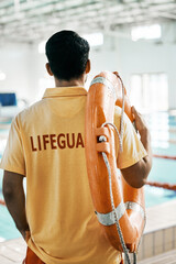 Swimming pool lifeguard and person with lifebuoy safety equipment and watch for rescue support,...
