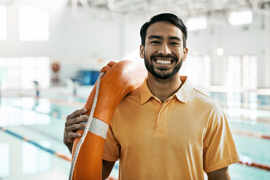 Lifeguard portrait, swimming pool and man with safety and lifebuoy for rescue support, help or life saving. Smile, equipment and first aid expert for protection, security and medical emergency