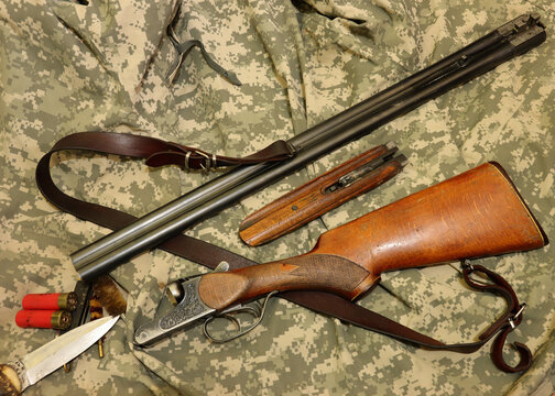 disassembled old shotgun and ammo