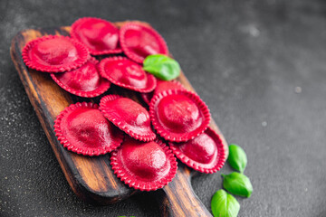 ravioli beet dye pasta red color cooking appetizer meal food snack on the table copy space food background rustic top view