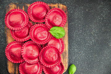 ravioli beet dye pasta red color cooking appetizer meal food snack on the table copy space food background rustic top view