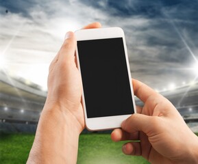 Sport Stadium and Person's Hand hold phone