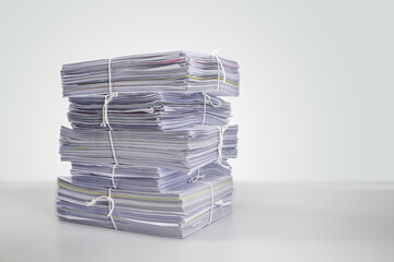 Pile or heap of financial business document paperwork stack on office desk concept of workload overtime or workplace paperless copy