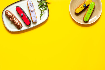 Many various glased eclairs with chocolate and berrie. Sweet food background