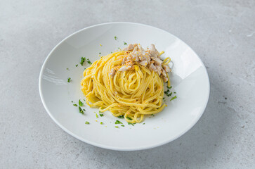 Italian pasta noodles with perch and carp roe isolated on grey stone surface