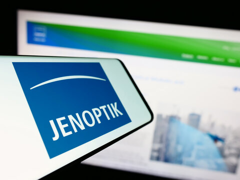Stuttgart, Germany - 09-10-2023: Mobile phone with logo of German photonics company Jenoptik AG on screen in front of business website. Focus on center-left of phone display.