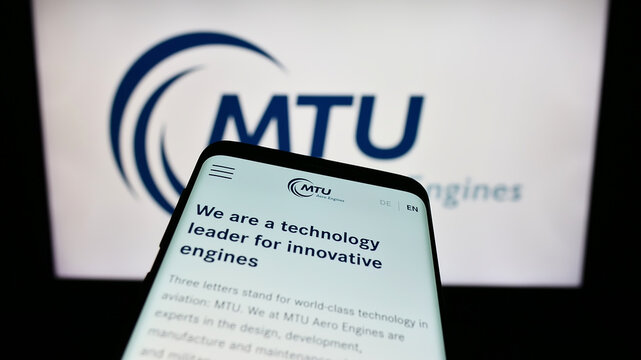 Stuttgart, Germany - 09-10-2023: Smartphone with website of German aviation company MTU Aero Engines AG on screen in front of business logo. Focus on top-left of phone display.