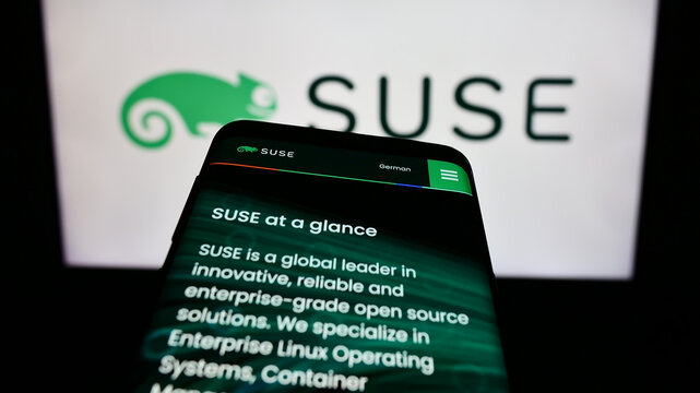 Stuttgart, Germany - 09-10-2023: Mobile phone with webpage of open-source software company SUSE S.A. on screen in front of business logo. Focus on top-left of phone display.