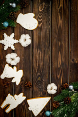 White Christmas gingerbread cookies with fir tree branches. New Year background