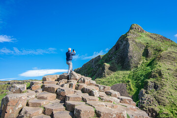 hiker on top of mountain: giants causeway