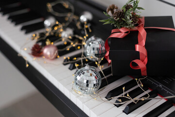 Piano keyboard with Christmas decoration, closeup.