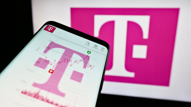 Stuttgart, Germany - 09-11-2023: Smartphone with website of telecommunications company Deutsche Telekom AG on screen in front of logo. Focus on top-left of phone display.