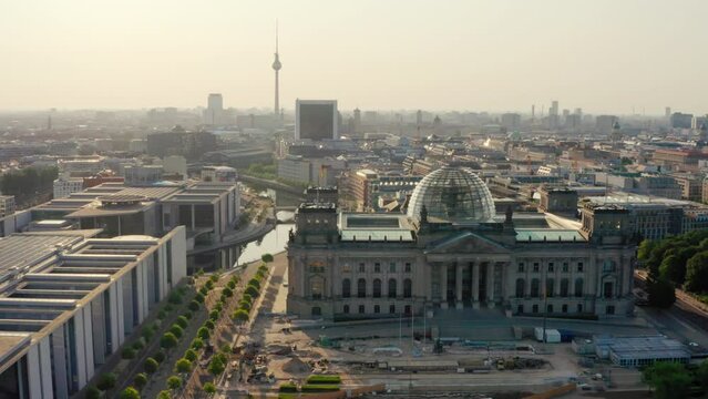 Establishing Aerial shot of Berlin Cityscape with Reichstag and German Federal Chancellery in Bundestag. Government Buildings and TV Tower as European Political Landmarks. Scenic 4K drone view