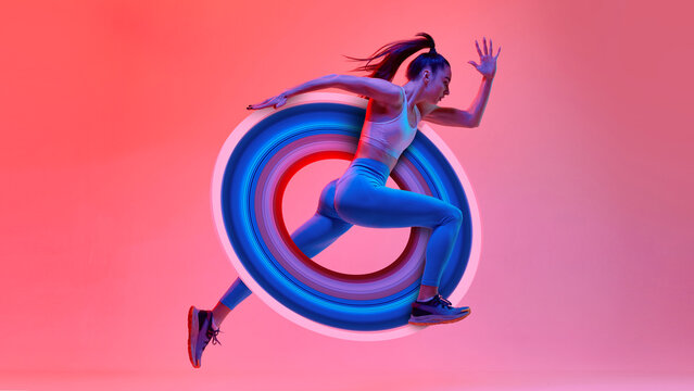 Young girl, athlete, runner in motion, training over pink studio background in neon light with abstract element. Contemporary art collage. Concept of sport, creativity, action and motion, health.