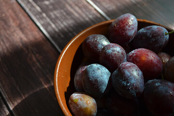 plums in a plate on the table. close-up photo of fruit