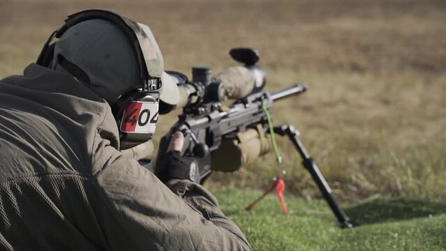 The shooter prepares to shoot in a prone position and makes a shot