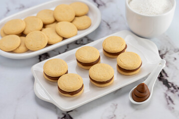 ingredients and mise en place for the preparation of cornstarch alfajores, filling the dulce de...