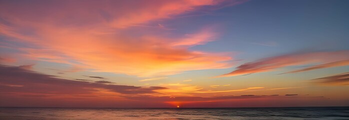 Naklejka na ściany i meble 海のホライゾンに広がる夕暮れのパノラマ：深い青色の海と鮮やかな空、夕日の光が雲をピンクとオレンジに染め上げる