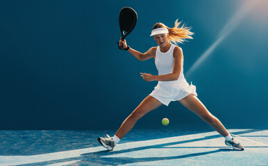 Female padel player in action on the court