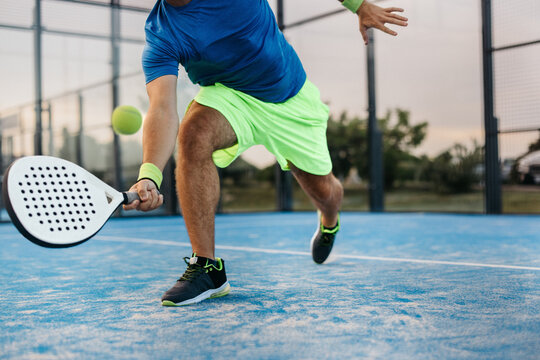 Athlete in a padel tournament receives impressive lob with expert padel stroke