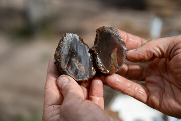 Craftsman pressing agate after cutting it.