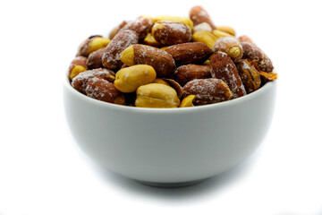 close up of roasted peanuts isolated on white background