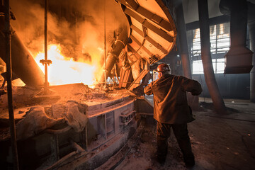 Steelworker at work near the arc furnace