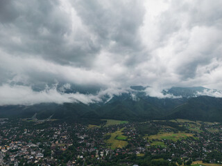 Fototapeta na wymiar Drone view of the Polish city of Zakopane and the Tatra mountains, the sky is covered with clouds, cloudy weather.