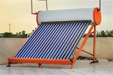 View of rooftop solar water heater from a house at Gujarat, India or Compact Non-Pressurized Vacuum Tube Solar Water Heater. solar heating system with evacuated solar water heater, boiler and radiator