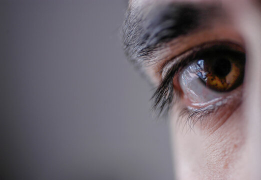 A watchful brown human eye looking at camera.