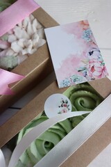 Two boxes with marshmallows. Zephyr flowers. Homemade marshmallows in a paper gift box. The box is tied with a ribbon tied into a bow. Label for the text. Close-up.