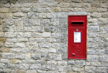traditional english letterbox built into a large stone wall