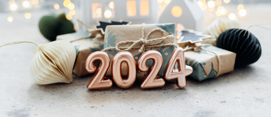 Christmas and New Year card. Number 2024 on holiday background. Christmas lights bokeh background. Holiday postcard. Happy New Year 2024 Card Concept