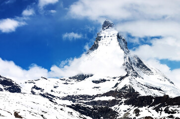 Panoramic view on Snow Mountain and cloudy with blue sky at Matterhorn Zermatt Switzerland