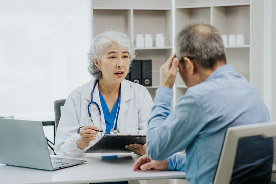 Asian female doctor and male patient talking health concept