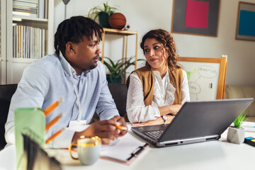 Portrait of young business people working together in home office. Couple teamwork startup concept