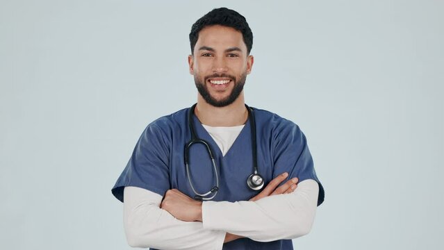 Man, medical nurse and portrait in studio with confidence, pride and arms crossed. Happy indian male, surgeon or healthcare worker on grey background for medicine or friendly specialist service
