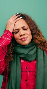 Forgetful young woman hits head with hand in disbelief, duh moment, studio