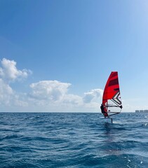 Athlete riding his IQ Foil windsurfing board in sea, training process 
