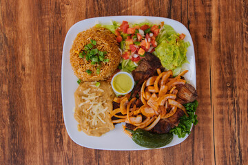 Mexican grilled steak with Mexican rice avocados and refried beans