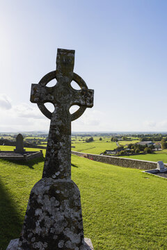 Celtic Cross On Grassy Hill With Stone Wall Under Blue Sky; Cashel, County Tipperary, Ireland