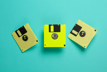 Yellow floppy disks on a blue background. Retro technology. Top view