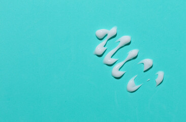 Smear of cream on blue background