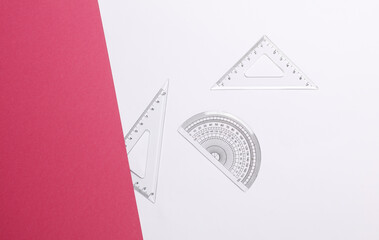 Set of rulers on white pink background. Back to school, geometry, exact sciences