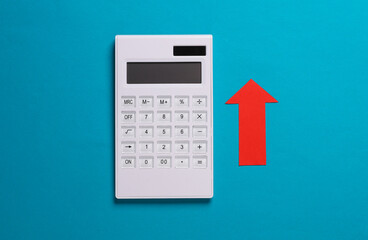 Calculator with a red growth arrow on a blue background. Business concept