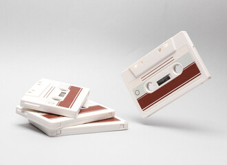 Retro audio cassettes levitating on white background. Minimalism