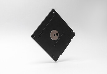 Retro floppy disk levitating on a gray background