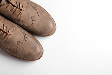 Stylish leather brogue shoes on a white background. Men's footwear. Top view