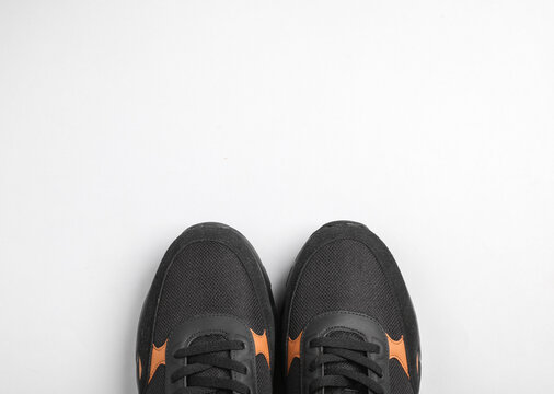 Black sports sneakers on white background. Top view. Flat lay