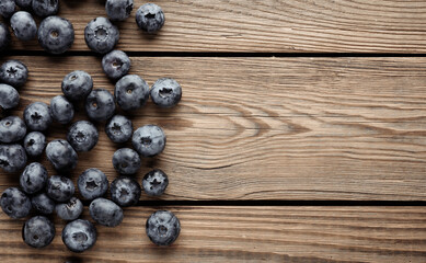 Blueberries on a wooden table. Top view. Copy space